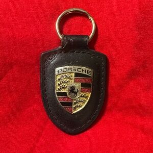 Genuine Metal on Leather PORSCHE keychain. Stuttgart Stallion middle of badge.